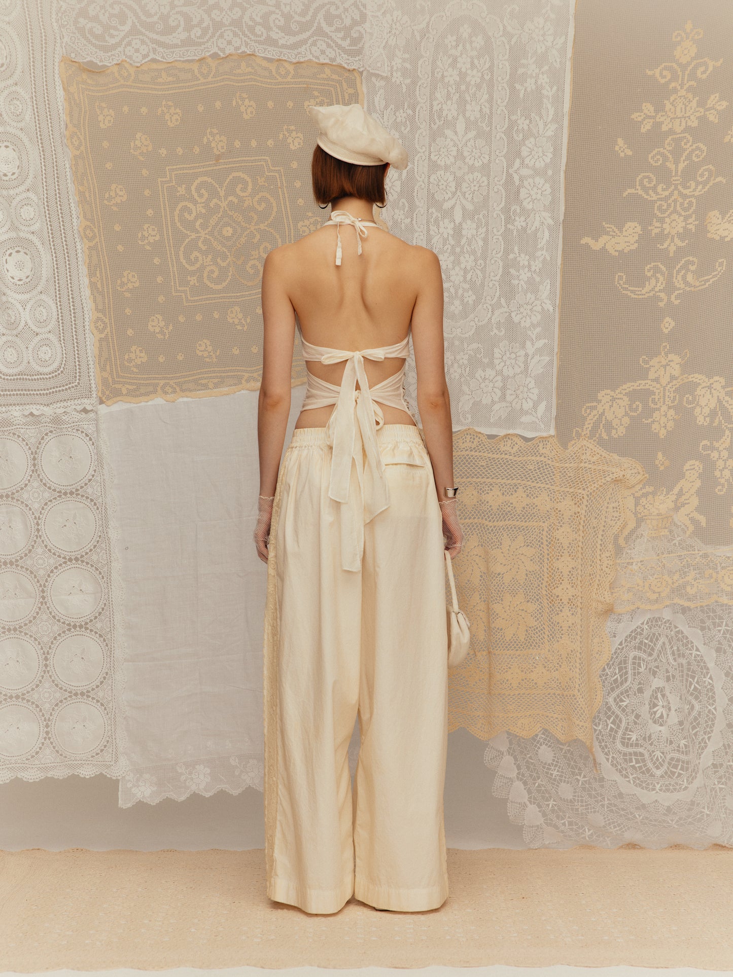 Cold-dyed with frilly ruffled collar, cinched waist and halter neck design